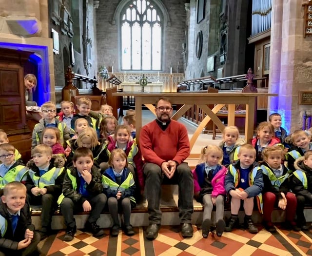 Youngsters try out vicar’s pulpit on church visit