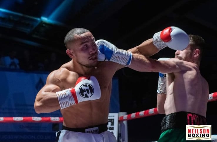 Boxer Liam O’hare ducking a haymaker (punch) and landing a blow to his opponent.