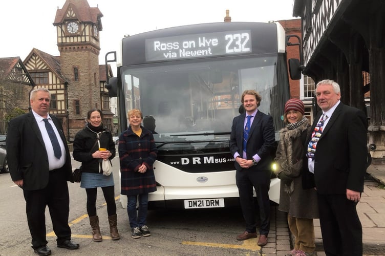 Staff and volunteers next to the new 232 bus