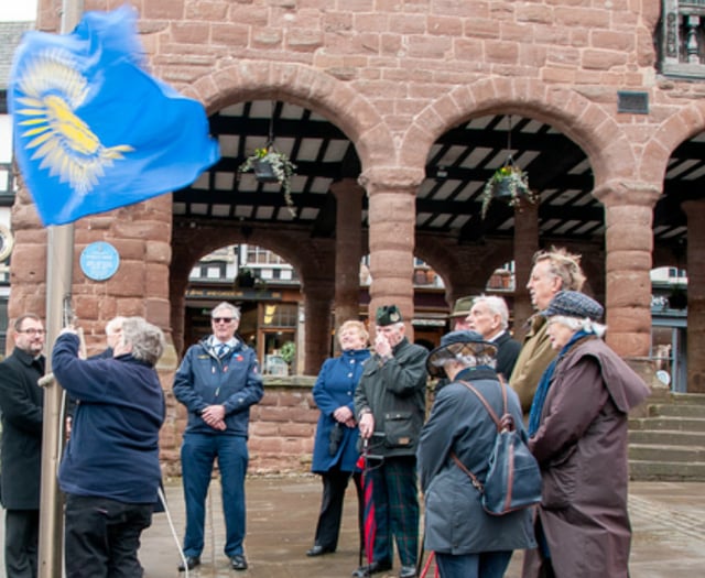 Commonwealth spirits un-dampened by weather during flag raising