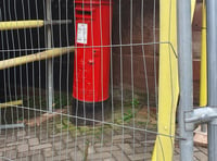 Building work puts postbox behind bars