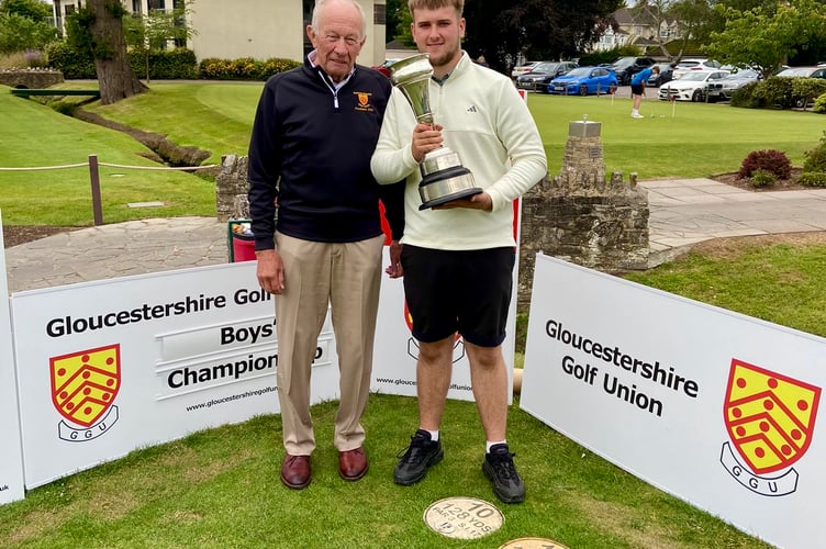 Leo Powell receives the trophy from Gloucestershire Golfing Union's President Ian Hughes. 