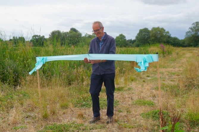 Kevin McCloud cuts the ribbon to open the Luston Wetlands