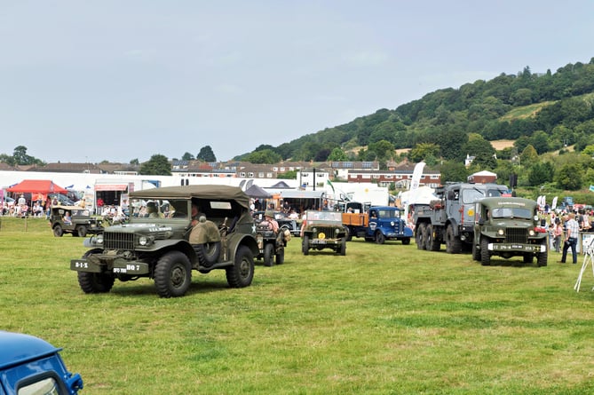 WWII vehicles parade in the ring